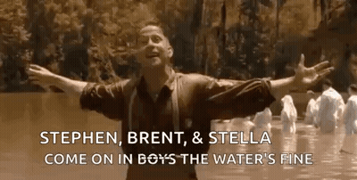 A Man Is Standing In A River With His Arms Outstretched . GIF