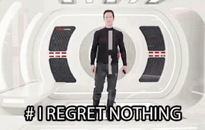 A Man Is Standing In A Room With The Words # I Regret Nothing On The Bottom . GIF