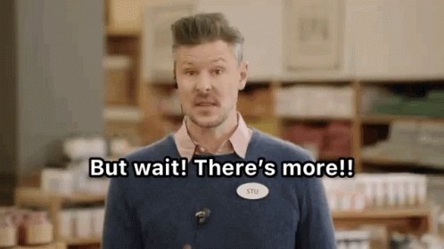 A Man Is Standing In A Store With A Name Tag That Says But Wait There 'S More . GIF