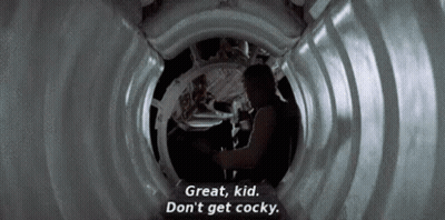 A Man Is Standing In A Tunnel And Talking To A Woman . GIF