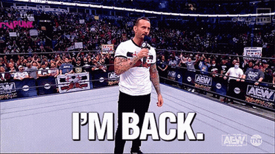 A Man Is Standing In A Wrestling Ring Holding A Microphone And Says I 'M Back GIF