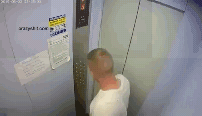 A Man Is Standing In An Elevator With A Sign On The Wall That Says ' Warning ' GIF