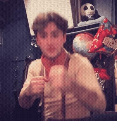 A Man Is Standing In Front Of A Balloon That Says Levis On It GIF