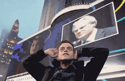 A Man Is Standing In Front Of A Billboard With His Hands On His Head . GIF