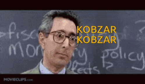 A Man Is Standing In Front Of A Blackboard With The Name Kobzar Written On It GIF