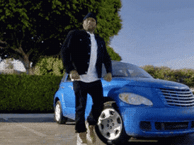 A Man Is Standing In Front Of A Blue Chrysler Car GIF