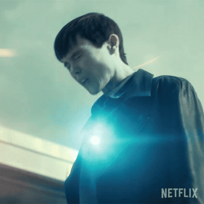 A Man Is Standing In Front Of A Blue Light And The Word Netflix Is On The Bottom GIF