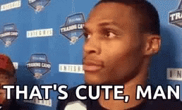 A Man Is Standing In Front Of A Blue Wall With The Words `` That 'S Cute , Man '' . GIF