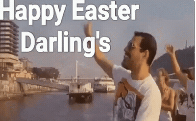 A Man Is Standing In Front Of A Body Of Water While A Group Of People Are Standing Behind Him . GIF