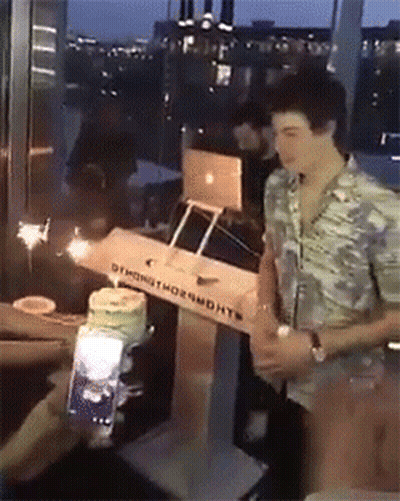 A Man Is Standing In Front Of A Box That Says ' Oymond Thornworth ' On It GIF