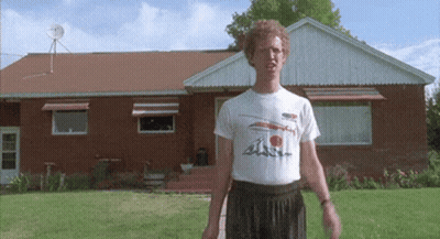A Man Is Standing In Front Of A Brick House Wearing A T-Shirt That Says ' A ' On It GIF