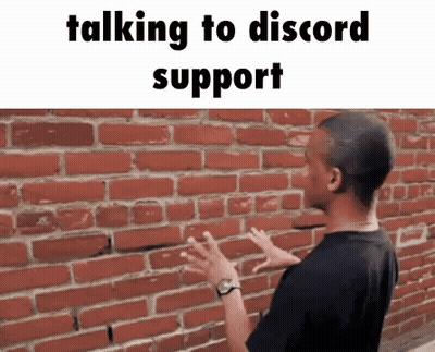 A Man Is Standing In Front Of A Brick Wall With His Hands Outstretched . GIF