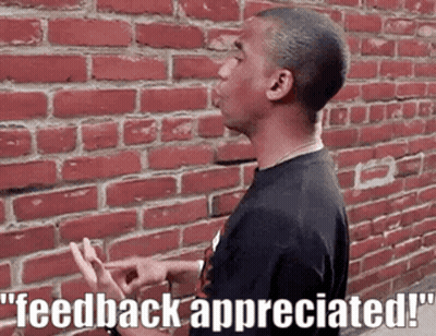 a man is standing in front of a brick wall with the words feedback appreciated