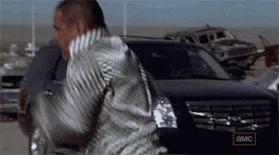 A Man Is Standing In Front Of A Car That Says Amc On The Side GIF