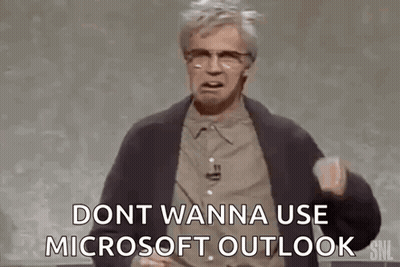 A Man Is Standing In Front Of A Chalkboard And Talking About Microsoft Outlook . GIF