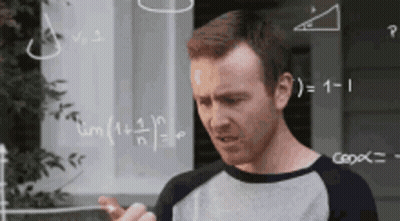 A Man Is Standing In Front Of A Chalkboard With Math Problems On It . GIF
