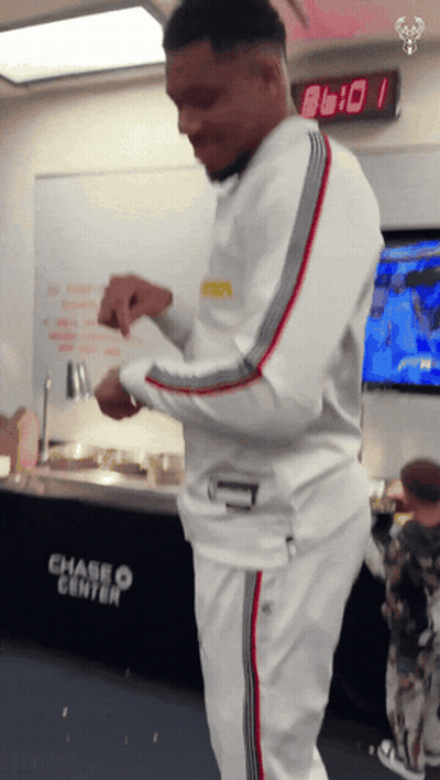 A Man Is Standing In Front Of A Chase Center Sign GIF