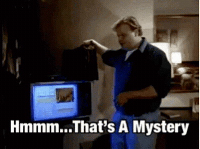 A Man Is Standing In Front Of A Computer And Says That 'S A Mystery GIF