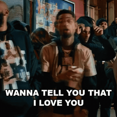 A Man Is Standing In Front Of A Crowd Of People And Saying `` Wanna Tell You That I Love You '' GIF
