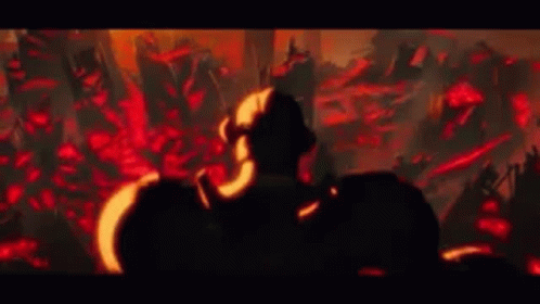 A Man Is Standing In Front Of A Crowd Of People In A Dark Room In A Video Game . GIF