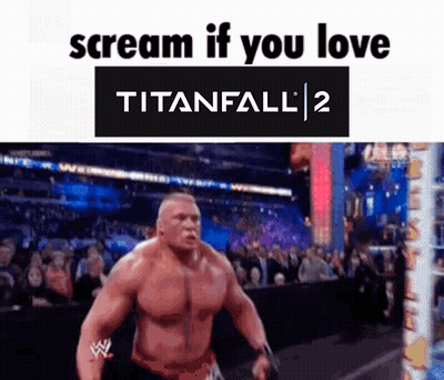 A Man Is Standing In Front Of A Crowd With The Words Scream If You Love Titanfall 2 Above Him . GIF