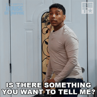 A Man Is Standing In Front Of A Door With The Words Is There Something You Want To Tell Me GIF