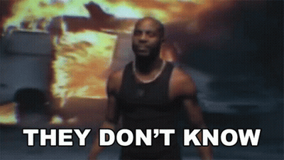 A Man Is Standing In Front Of A Fire With The Words " They Don 'T Know " GIF