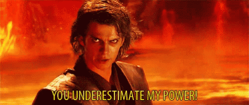 A Man Is Standing In Front Of A Fire With The Words `` You Underestimate My Power '' Written Above Him . GIF