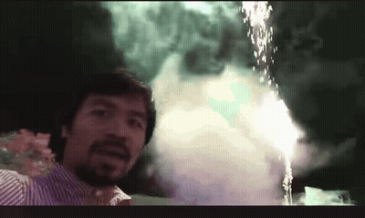 A Man Is Standing In Front Of A Fireworks Display GIF