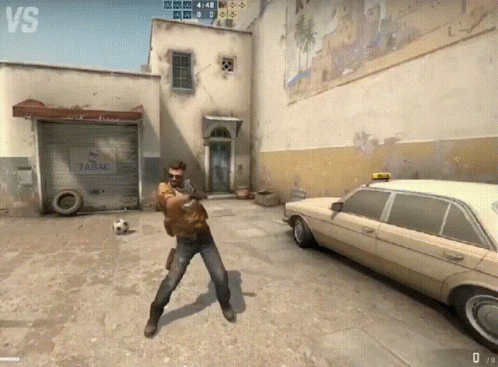 A Man Is Standing In Front Of A Garage That Says Tabac On It GIF