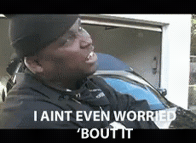 A Man Is Standing In Front Of A Garage With The Words I Aint Even Worried Bout It GIF