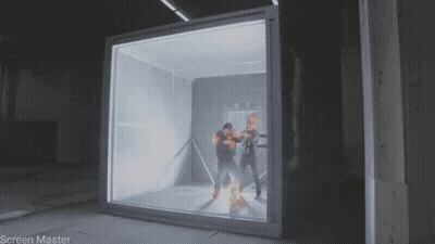 A Man Is Standing In Front Of A Glass Box That Says Screen Master On It GIF