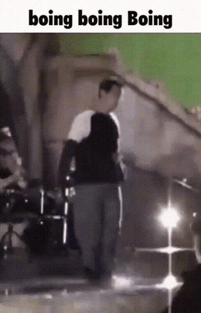 A Man Is Standing In Front Of A Green Screen With The Words Boing Boing Boing GIF