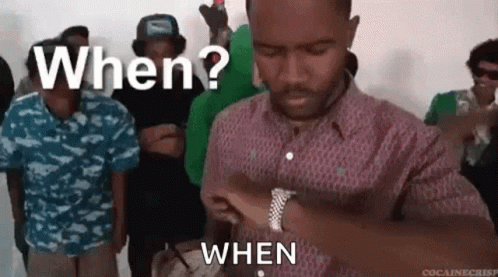 A Man Is Standing In Front Of A Group Of People And Asking When ? When . GIF