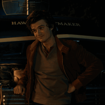 A Man Is Standing In Front Of A Hawk Maker Truck GIF