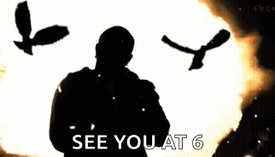 A Man Is Standing In Front Of A Huge Explosion With A Bird Flying In The Background . GIF