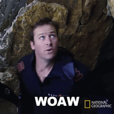 A Man Is Standing In Front Of A Large Rock And The Word Woaw Is On The Screen GIF