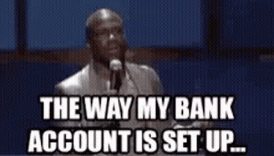A Man Is Standing In Front Of A Microphone And Saying `` The Way My Bank Account Is Set Up . '' GIF