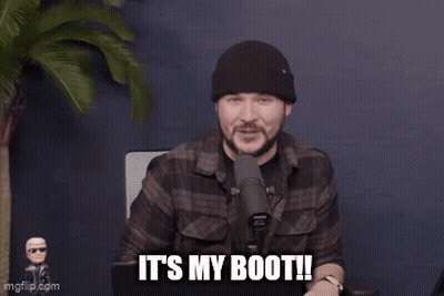 A Man Is Standing In Front Of A Microphone And Says It 'S My Boot . GIF