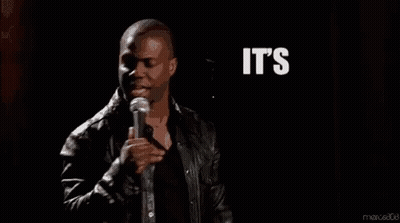 A Man Is Standing In Front Of A Microphone With The Words `` It 'S About To Go Down '' Written In White Letters . GIF