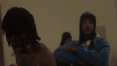 A Man Is Standing In Front Of A Mirror Without A Shirt On . GIF