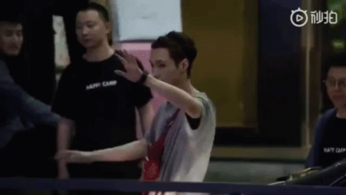 A Man Is Standing In Front Of A Ping Pong Table Making A Funny Face . GIF