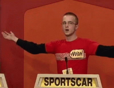 A Man Is Standing In Front Of A Podium That Says Sportscar GIF