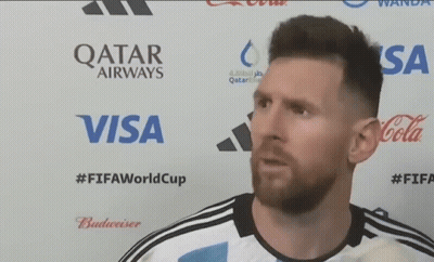 A Man Is Standing In Front Of A Qatar Airways Visa And Coca Cola Advertisement GIF