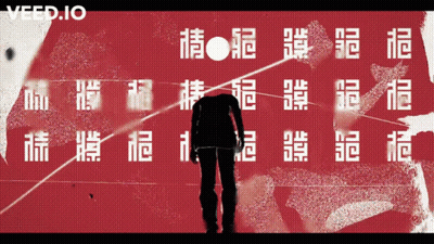 A Man Is Standing In Front Of A Red Wall With Chinese Characters And The Word Veed.io On The Bottom GIF