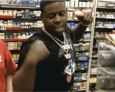 A Man Is Standing In Front Of A Shelf With A Price Tag Of $ 549 GIF