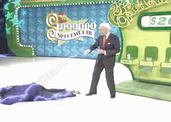 A Man Is Standing In Front Of A Sign That Says 1,000,000 Spectacular GIF