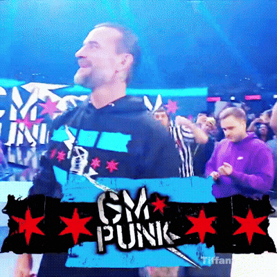 A Man Is Standing In Front Of A Sign That Says Cm Punk GIF