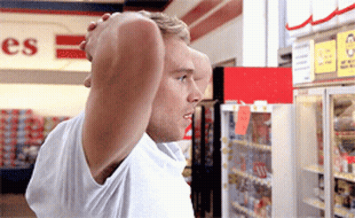 A Man Is Standing In Front Of A Sign That Says ' Es ' On It GIF