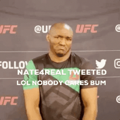 A Man Is Standing In Front Of A Sign That Says Follow Nate4real Tweeted Lol Nobody Cares Bum GIF